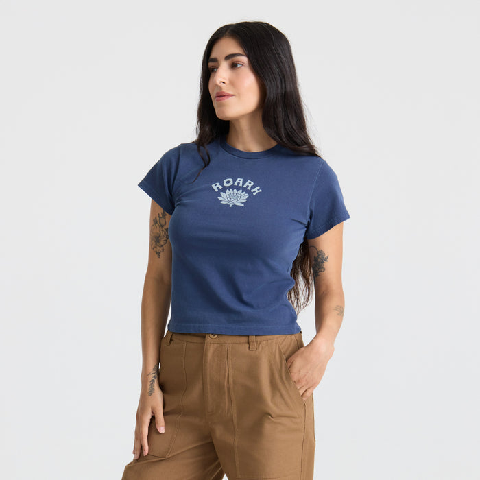 Man smiling in a casual nep tee paired with denim, exuding a sense of adventure and comfort ideal for travel and outdoor activities.