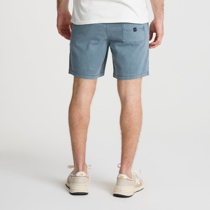 on-model Bermuda shorts on a sandy beach evoking the spirit of adventure and exploration aligned with Roark's ethos.