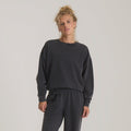Made To Fade Fleece Hoodie in vintage black worn by model, cropped silhouette with ribbed cuffs and hem visible