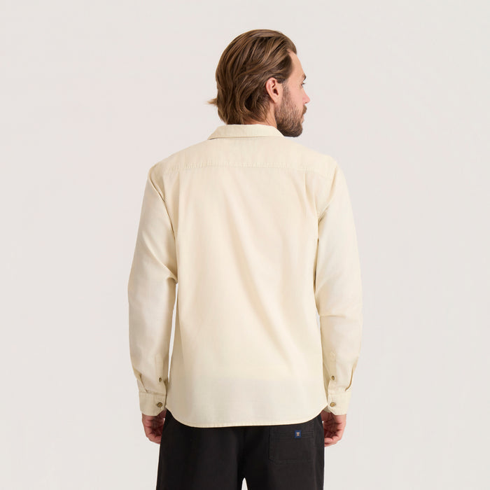Man wearing cream-colored long sleeve button up shirt with collar, shown from back view against neutral background