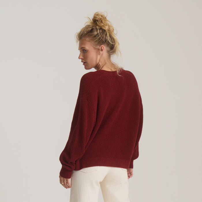 Made To Fade Sweater in cherrywood burgundy worn by model from behind, showing relaxed fit and ribbed knit texture