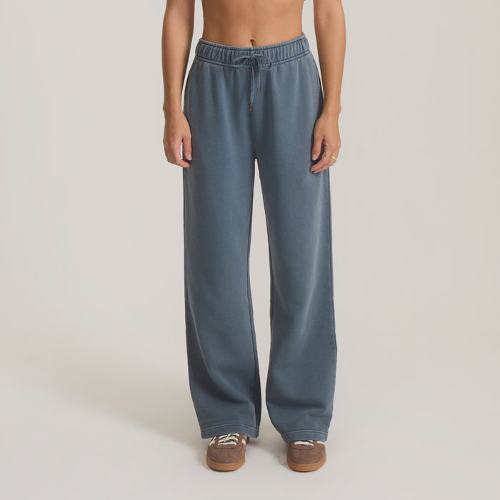 Slate blue wide-leg Made To Fade pants with elastic waistband and drawstring, styled on model with brown sneakers
