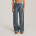 Slate blue wide-leg Made To Fade pants with elastic waistband and drawstring, styled on model with brown sneakers
