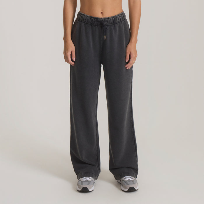 Black Made To Fade pants with drawstring waist and wide-leg fit, styled on model with sneakers