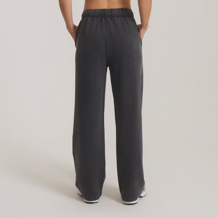 Made To Fade Pants in vintage black worn by model from back, showing relaxed fit and elasticated waistband