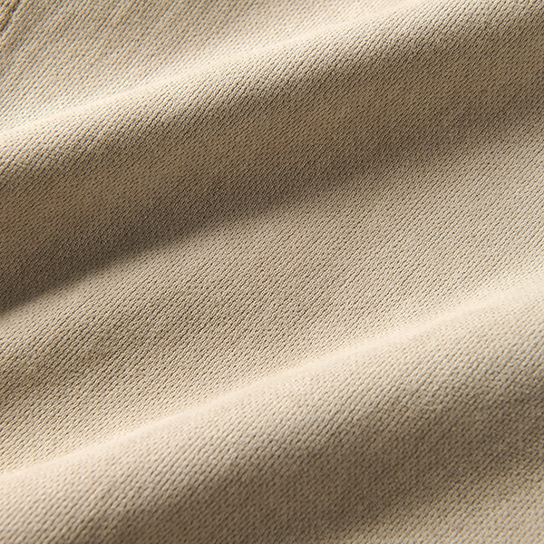 Close-up texture of high-quality brown woven linen fabric, showcasing the durability and style suitable for adventure and travel gear.