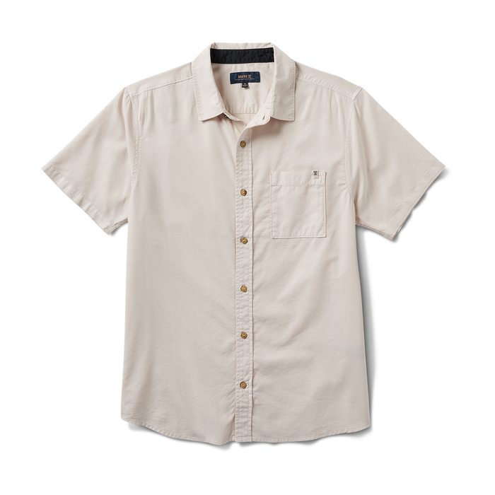 Front view of the Roark Made To Fade Short Sleeve Button Up Shirt in Washed Bone, featuring a classic button-front design and chest pocket with logo detail.