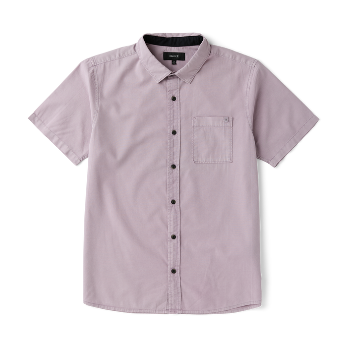 Close-up of a durable Roark adventure dress shirt featuring a sturdy collar, buttons, and practical pockets, designed for outdoor and travel enthusiasts.
