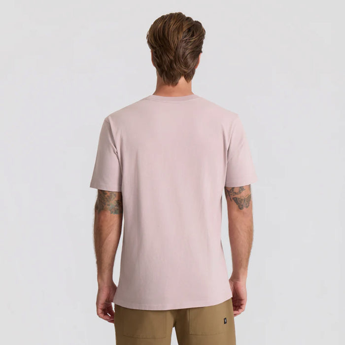 Active woman in a vivid pink Roark shirt exploring outdoors