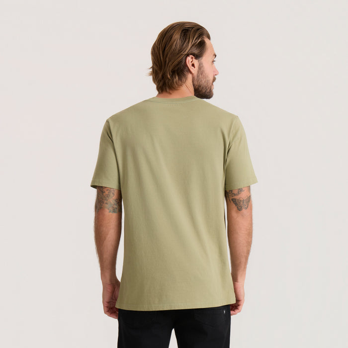 Washed dusty sage short sleeve tee on male model shown from back view wearing black pants