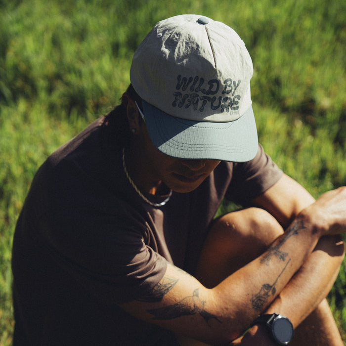 Roark Mathis 5 Panel Strapback Hat displayed against an outdoor backdrop, perfect for adventure and travel