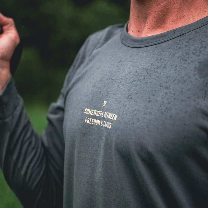 Active man wearing Roark Mathis Long Sleeve Tee with crew neck and full sleeves, perfect for outdoor adventures.