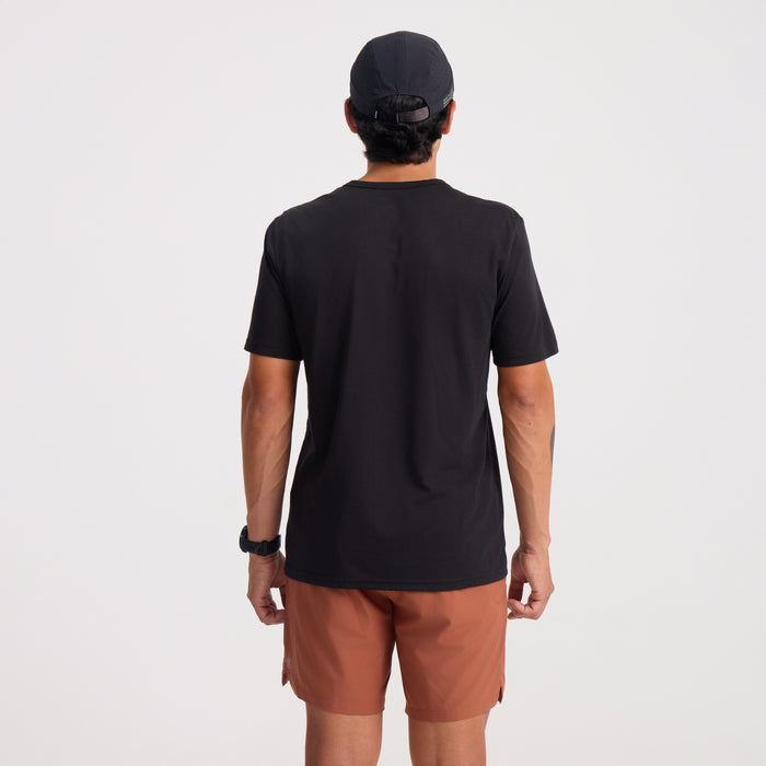 Active black shirt designed for adventure and outdoor activities, displayed in a natural setting.