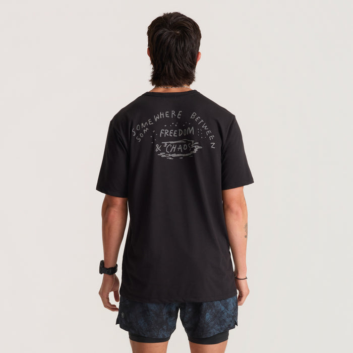 Close-up of a stylish, black active T-shirt designed for adventure and travel by Roark, highlighting the durable sleeve and comfortable neck design.