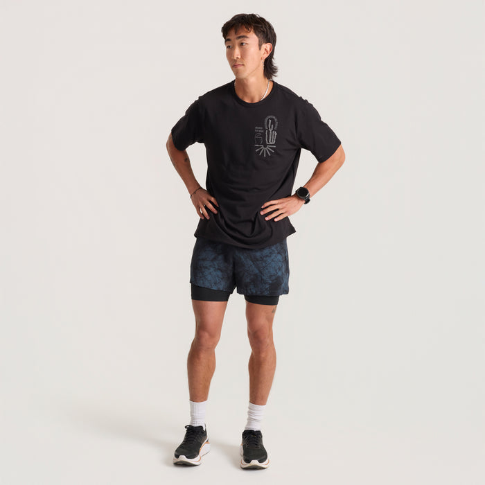 Model wearing versatile boardshorts perfect for adventure and travel by Roark, showcasing a sleek design that transitions seamlessly from trail to water.
