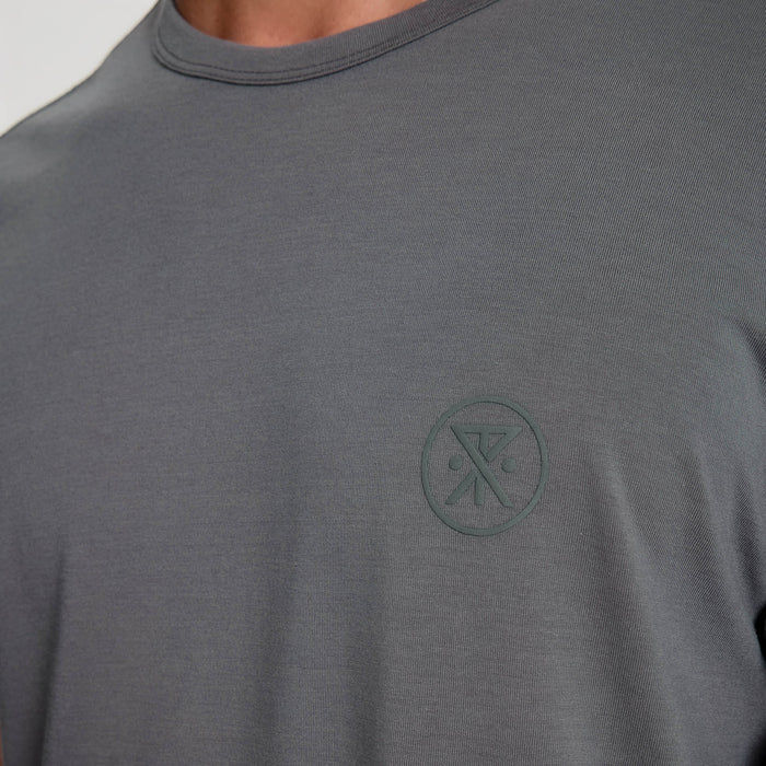 Man in a long-sleeved grey active shirt and denim, ready for an outdoor adventure