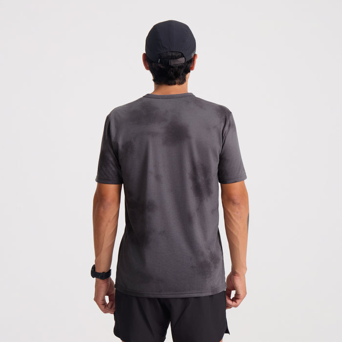 Active person wearing a grey and silver Roark adventure shirt, designed for outdoor activities and travel.