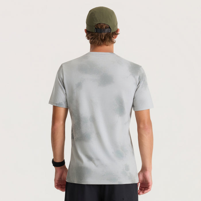 Mathis Active Allover Short Sleeve Tee in grey worn by model from back view with olive green cap