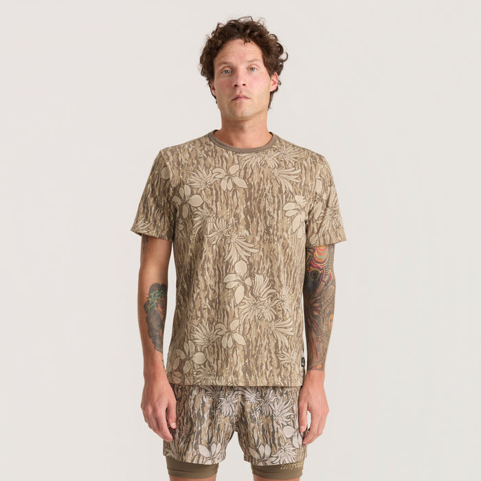 Active camouflage shirt and boardshorts with unique motifs, perfect for adventure and travel, displayed in a dynamic outdoor setting.