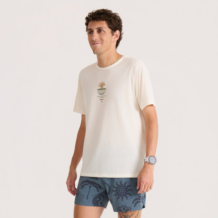 Mathis Active Graphic Short Sleeve Tee in unbleached cream worn by man with embroidered plant motif on chest
