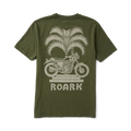 Adventurous biker wearing a versatile Roark active shirt while riding a motorcycle through a scenic route