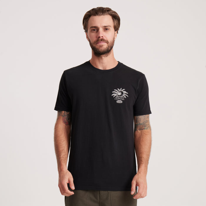 Model wearing the Roark black graphic tee, featuring a small palm tree design on the chest. Casual and versatile for adventures or everyday wear.