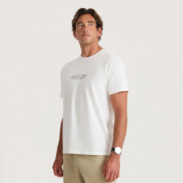 White Moto Premium T-shirt with small chest logo worn by man in beige shorts against neutral background