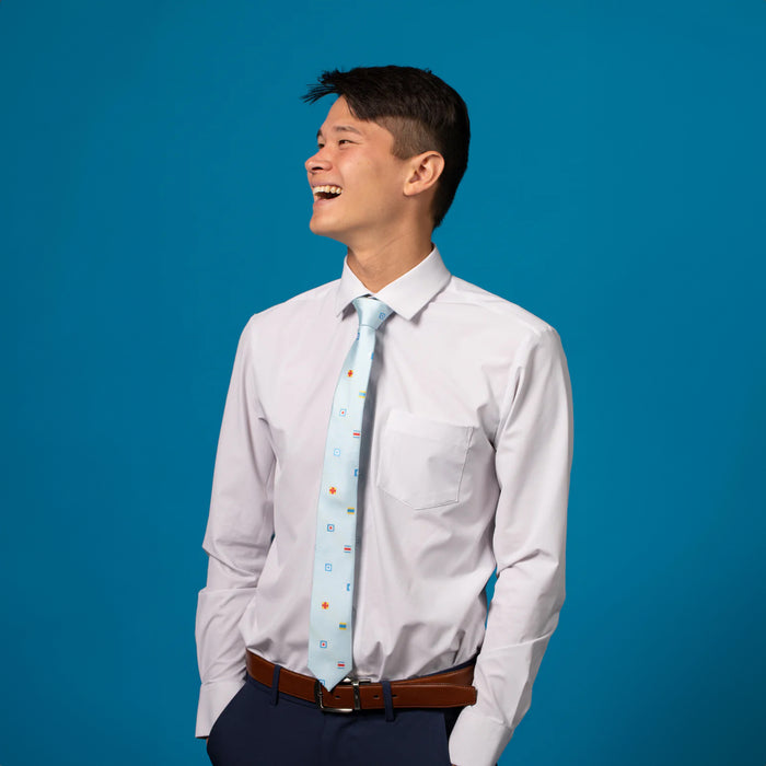 Light blue tie with colorful flag patterns on white shirt