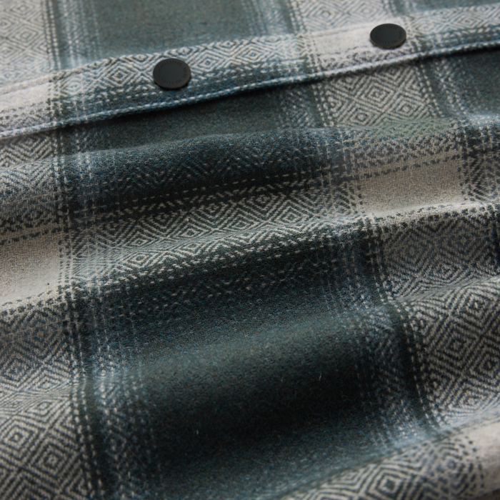 Nordsman 2.0 long sleeve flannel in dark slate with geometric woven pattern and black button details, close-up view