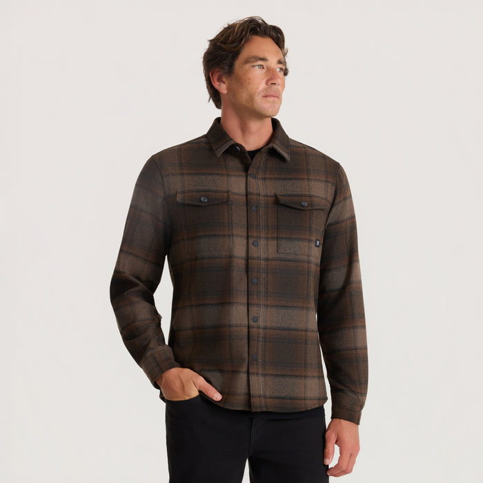 Brown plaid long sleeve flannel shirt on male model, worn with chest pockets and button front closure