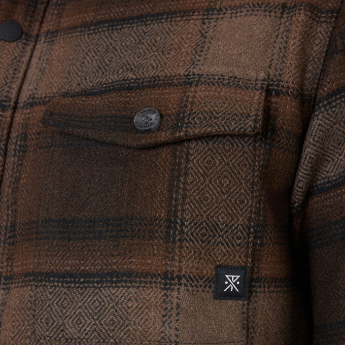 Rust brown flannel shirt with geometric diamond pattern and dark stripes, featuring chest pocket with button and brand label visible