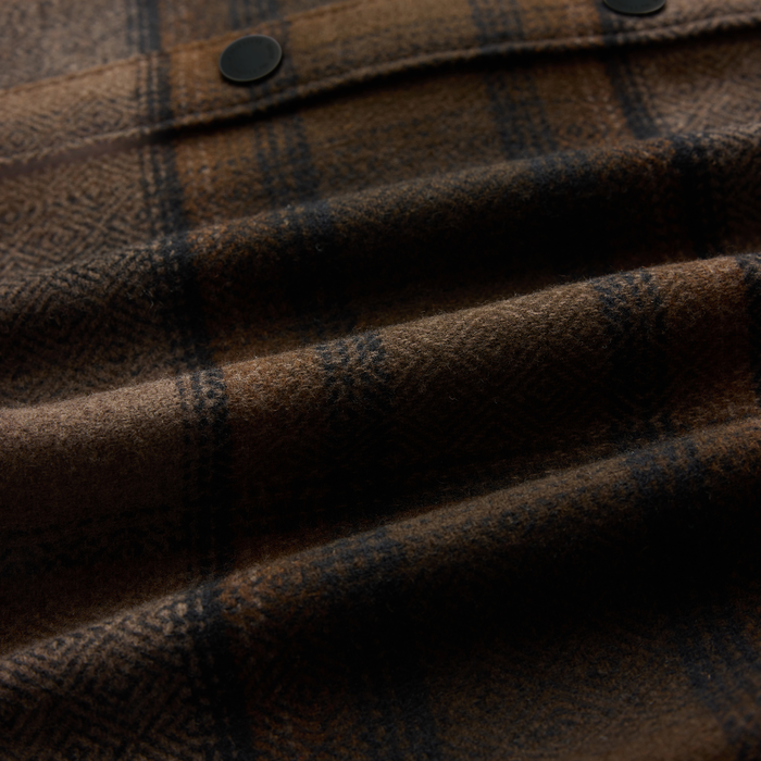 Nordsman 2.0 long sleeve flannel in rust with dark plaid pattern and black button detail, close-up fabric texture view