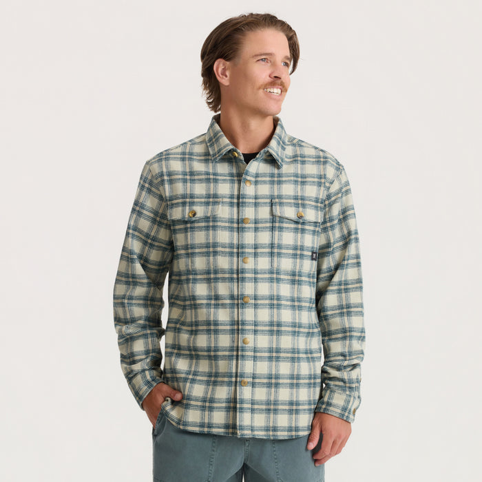 Men's Nordsman 2.0 long sleeve flannel shirt in sand and blue plaid with chest pockets, worn by model against neutral background