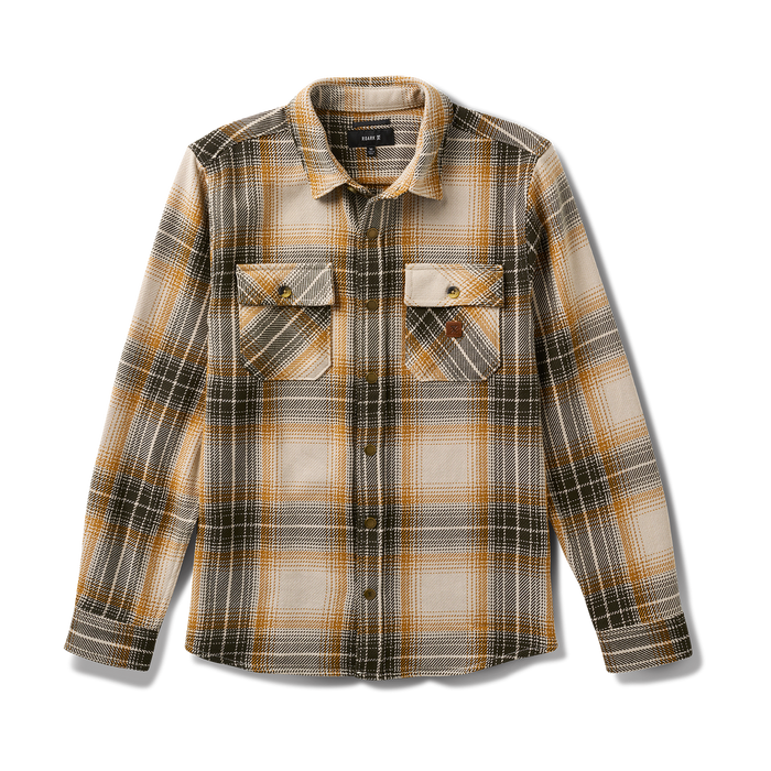 Close-up of a rugged denim and tartan plaid pocket, showcasing durable textiles perfect for adventure and travel.