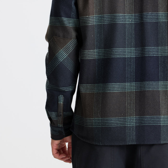 Exploring the unknown with Roark gear in a rustic, outdoor setting.