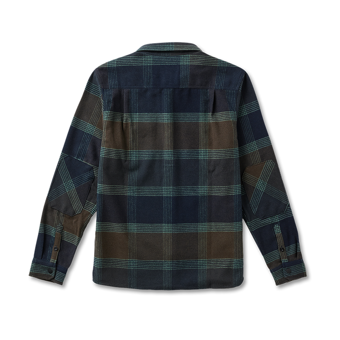 Rugged mountain terrain with a sweeping valley and towering stone massif, epitomizing Roark's adventure and travel aesthetic.