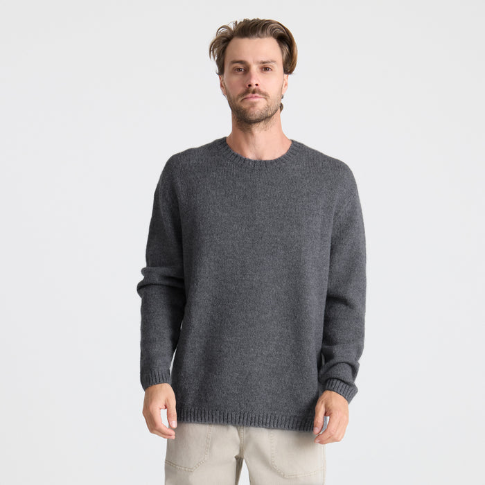 Adventurous traveler in a long-sleeved Roark T-shirt exploring rugged terrain