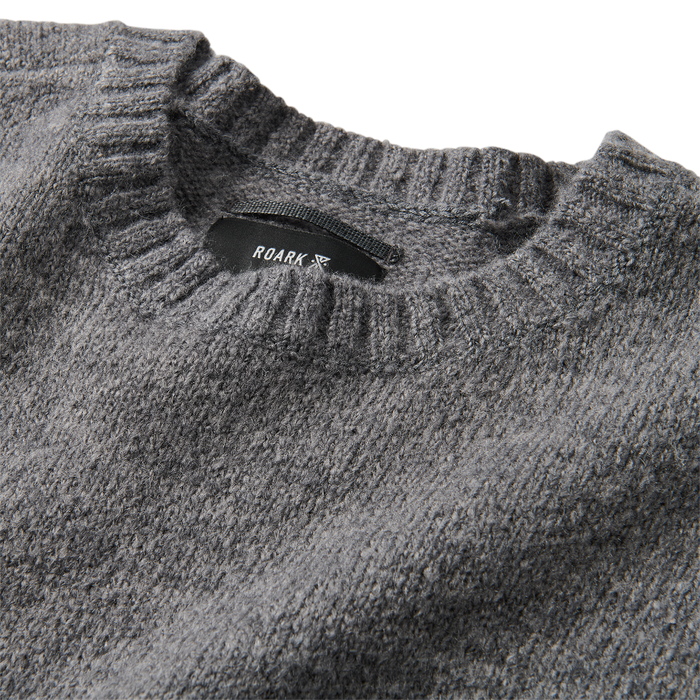 Close-up texture of a high-quality silver woolen fabric, ideal for adventure and outdoor apparel by Roark.