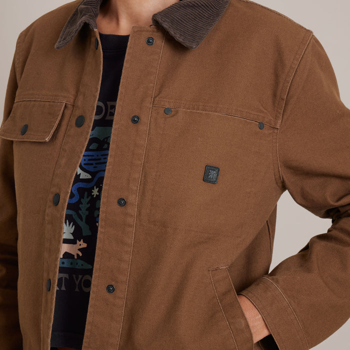 Roark Open Roads canvas jacket in outdoor travel setting, highlighting durability and style ideal for adventure.