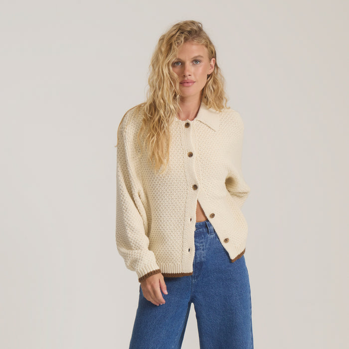 Open Roads Cardigan in bone cream with brown buttons worn on model over blue jeans, front view