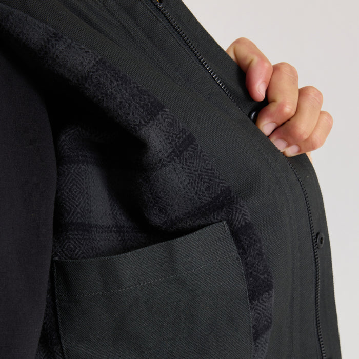 Open Roads Waxed Canvas Jacket in Onyx, detail shot showing textured fabric and front pocket on model