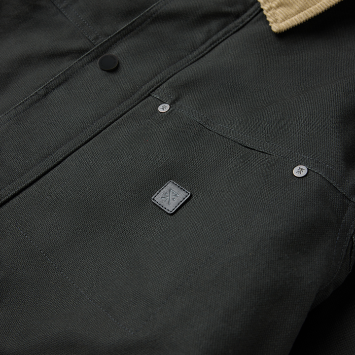 Open Roads Waxed Canvas Jacket in onyx black with metal buttons and branded square patch detail visible on front closure