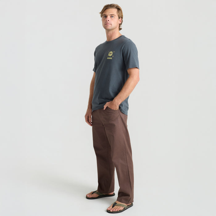 Man standing in a natural outdoor setting, highlighting a torso and pocket detail, exuding adventure and exploration.
