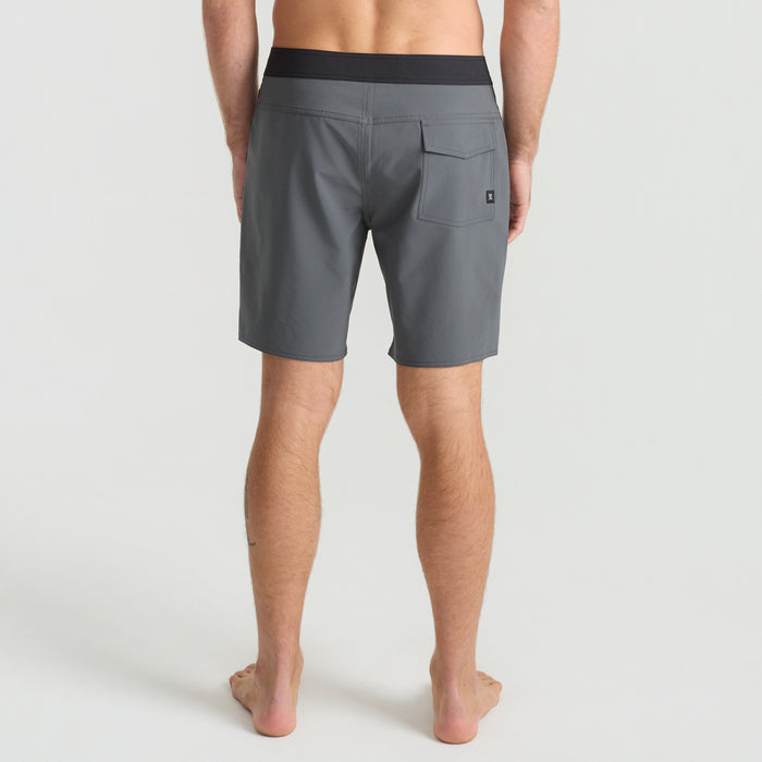 Pair of Roark Bermuda shorts laid out on a rustic wooden surface, perfect for adventure and travel.