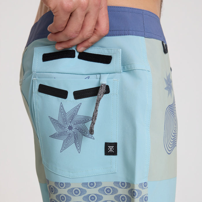 Stylish and durable Roark boardshorts displayed in a natural outdoor setting, perfect for adventure and travel.