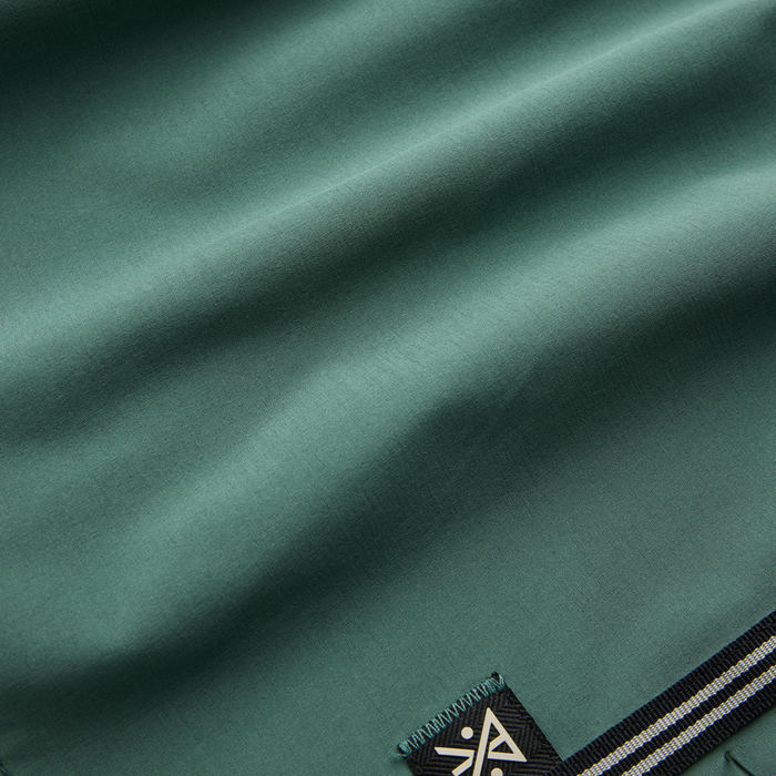 Passage Boardshorts in slate green with black and white stripe detail at waistband, flat lay close-up