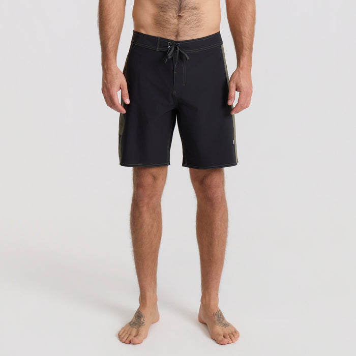 Man on vacation enjoying outdoor recreation in stylish Roark boardshorts, perfect for adventure and leisure.
