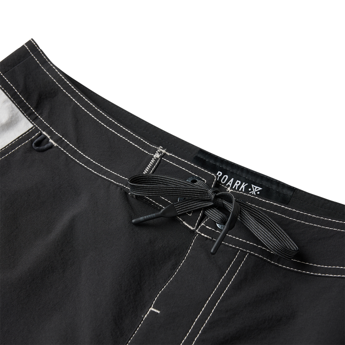 Roark Passage Panel Boardshorts in black with white contrast stitching, detail shot of waistband and drawstring closure