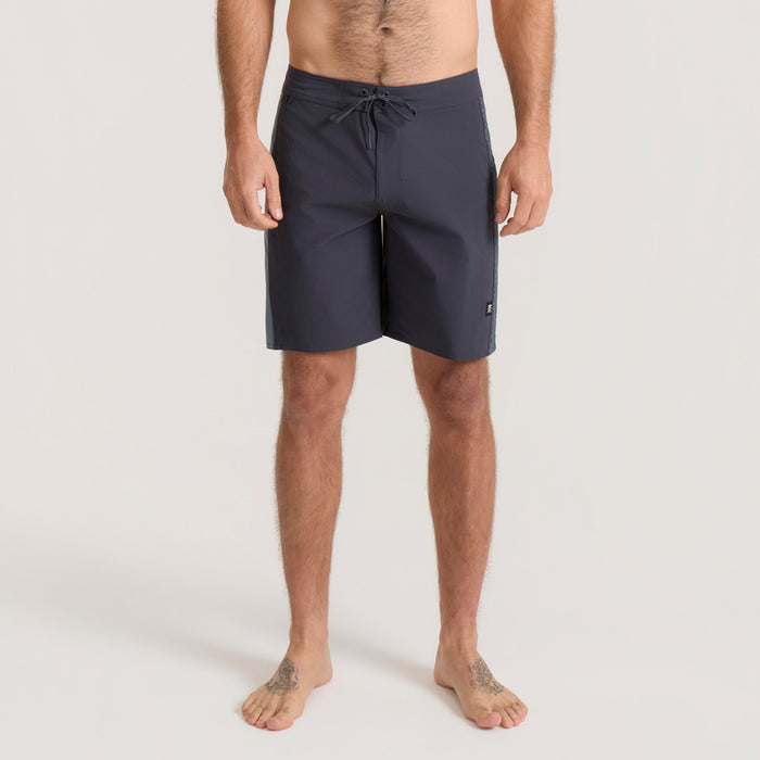Navy blue Roark Passage Panel Boardshorts with drawstring waistband displayed on male model from waist down