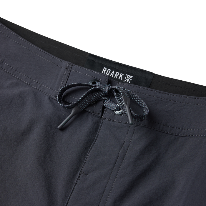 Black Roark Passage Panel Boardshorts with drawstring waistband and black branded label on flat lay display